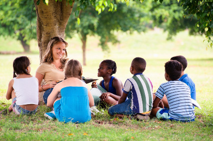 Kids learning under a tree